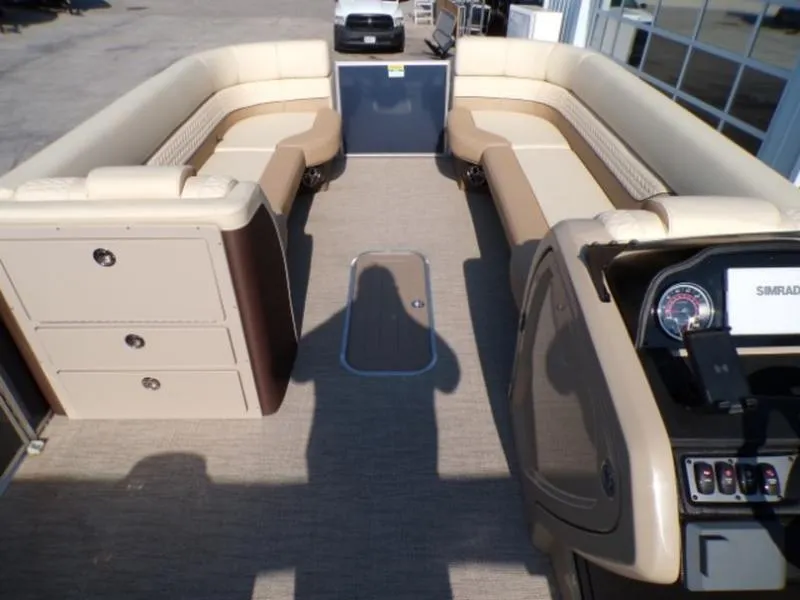 Slide: The Image of Interior of 2025 Godfrey Monaco 255 DFL pontoon boat with beige seating and control panel. - 15