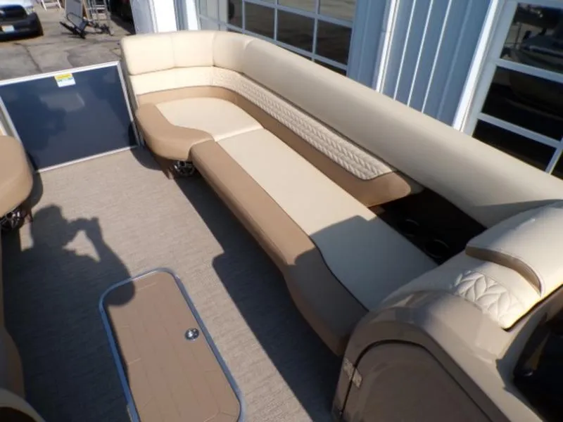 Slide: The Image of Luxurious seating on 2025 Godfrey Monaco 255 DFL pontoon boat, featuring beige and brown upholstery. - 18