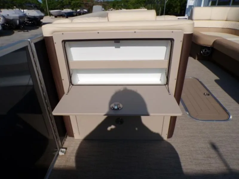 Slide: The Image of 2025 Godfrey Monaco 255 DFL boat interior with open storage compartment and seating area. - 19