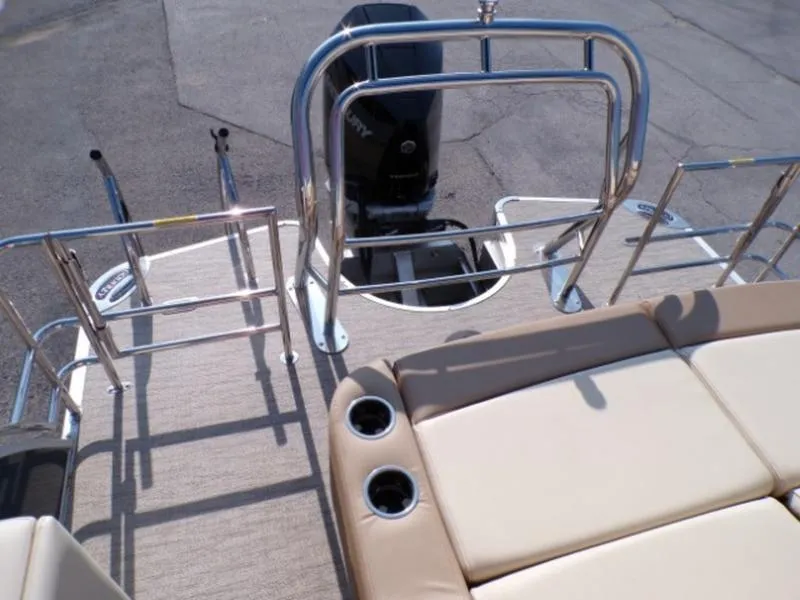 Slide: The Image of 2025 Godfrey Monaco 255 DFL boat deck with seating and motor, featuring stainless steel railings. - 24