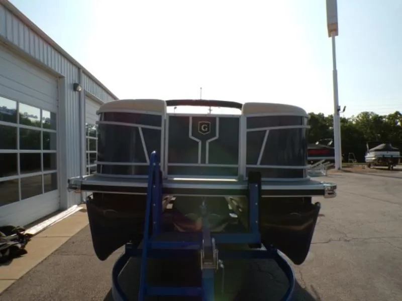 Slide: The Image of 2025 Godfrey Monaco 255 DFL pontoon boat on display outside a showroom. - 3