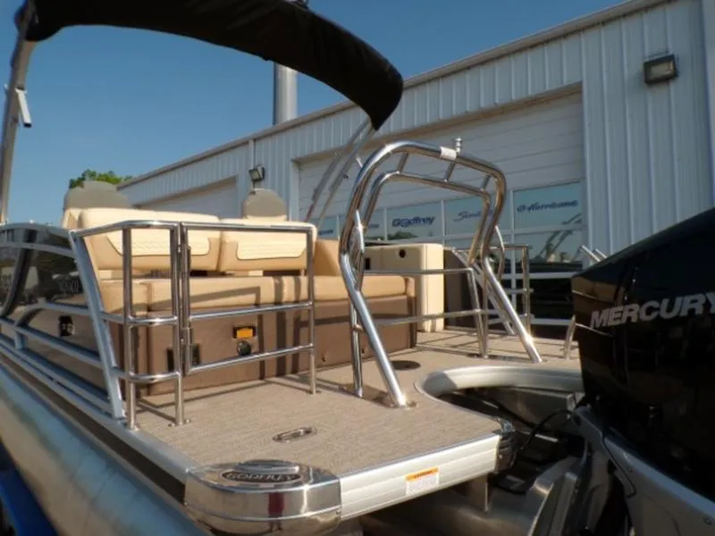 Slide: The Image of 2025 Godfrey Monaco 255 DFL boat with Mercury engine, docked near a building. - 4