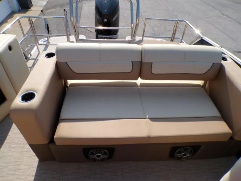 Slide: The Image of Luxury seating on 2025 Godfrey Monaco 255 DFL boat with cup holders and speakers. - 6
