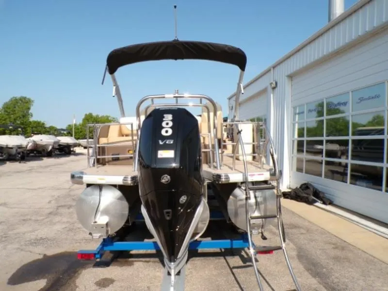 Slide: The Image of 2025 Godfrey Monaco 255 DFL boat with 300 V8 engine, parked outside a showroom. - 8