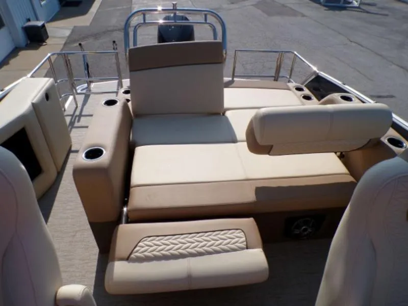 Slide: The Image of 2025 Godfrey Monaco 255 DFL boat interior with beige seating and cup holders. - 9