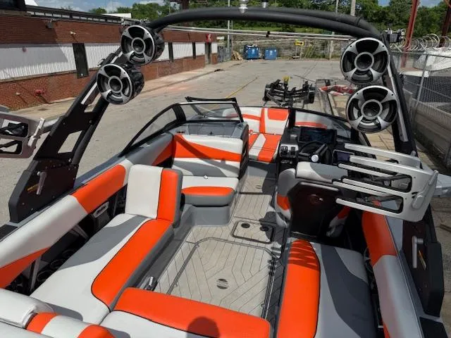 Slide: The Image of 2019 Malibu Wakesetter 22 MXZ interior with orange and gray seating, advanced sound system. - 23