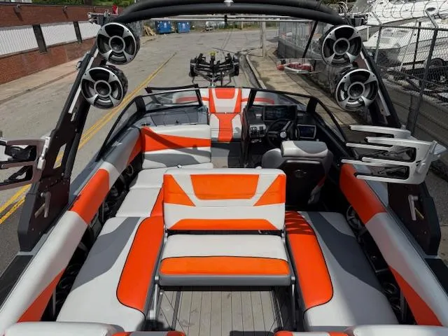 Slide: The Image of 2019 Malibu Wakesetter 22 MXZ interior with orange and gray seating, advanced sound system. - 24