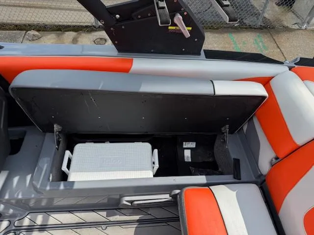 Slide: The Image of 2019 Malibu Wakesetter 22 MXZ boat interior with storage compartment and cooler. - 26