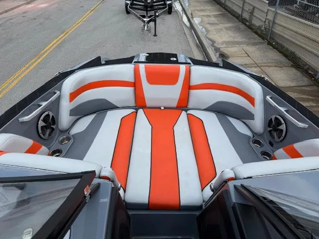 Slide: The Image of 2019 Malibu Wakesetter 22 MXZ boat interior with orange and gray seating. - 6