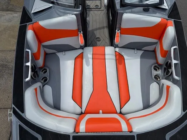 Slide: The Image of 2019 Malibu Wakesetter 22 MXZ boat interior with orange and gray seating. - 8