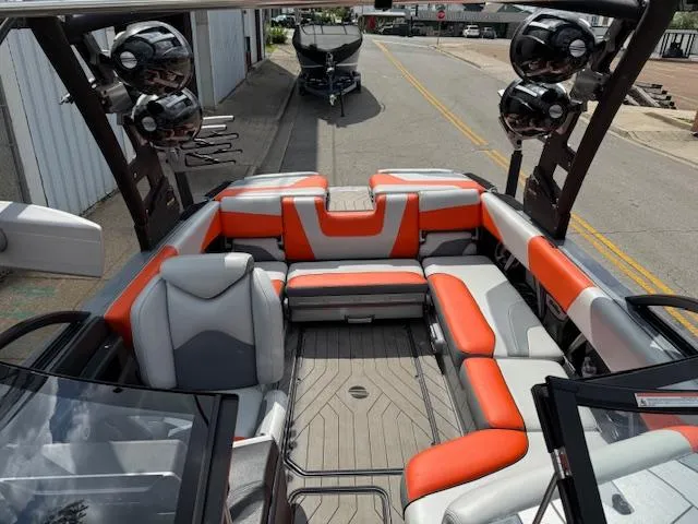 Slide: The Image of 2019 Malibu Wakesetter 22 MXZ boat interior with orange and gray seating. - 9