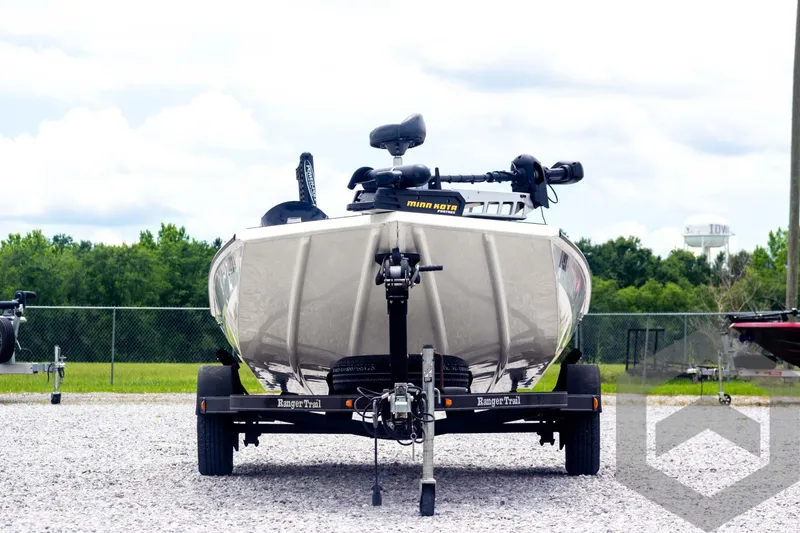 Slide: The Image of 2019 Ranger RT188 boat on trailer, front view, parked on gravel lot. - 2