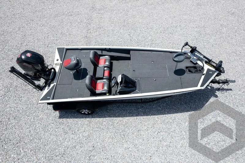 Slide: The Image of 2019 Ranger RT188 fishing boat with motor, black and red seats, on a gravel surface. - 43