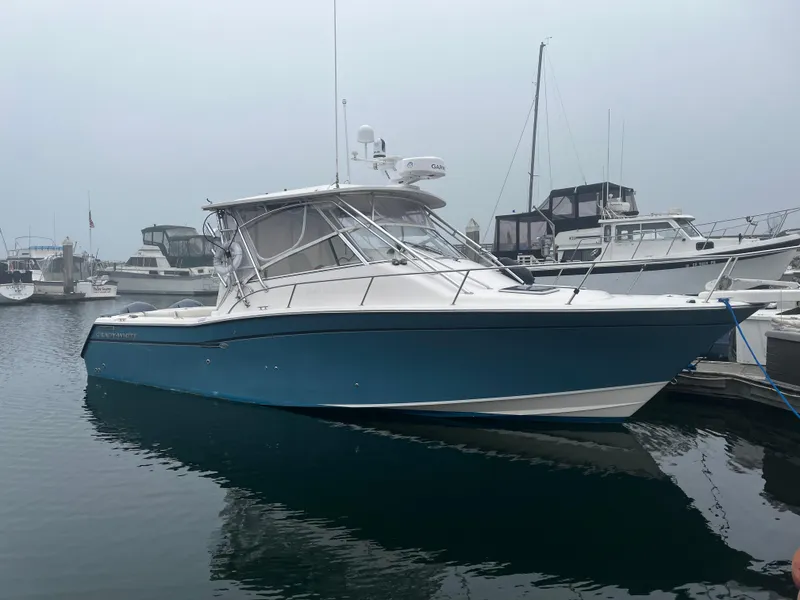 The Image of 2003 Grady-White 33 Express boat docked in a marina on a foggy day. - 1