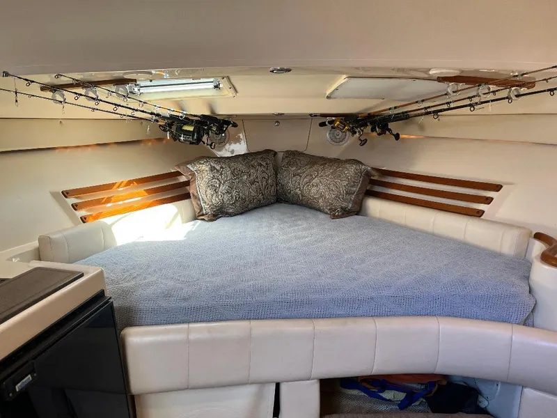 Slide: The Image of Interior cabin of 2003 Grady-White 33 Express with bed and fishing rods. - 14