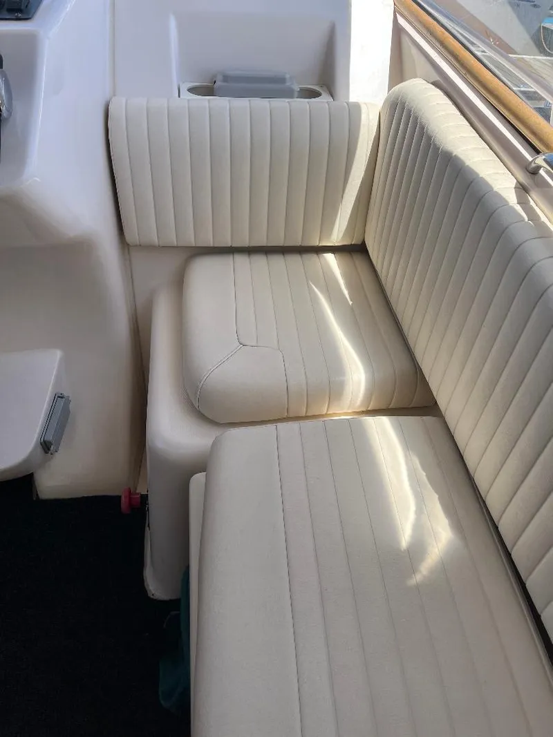 Slide: The Image of 2003 Grady-White 33 Express boat interior with white cushioned seating. - 19