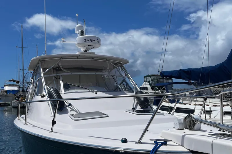 Slide: The Image of 2003 Grady-White 33 Express boat docked at marina under blue sky. - 6