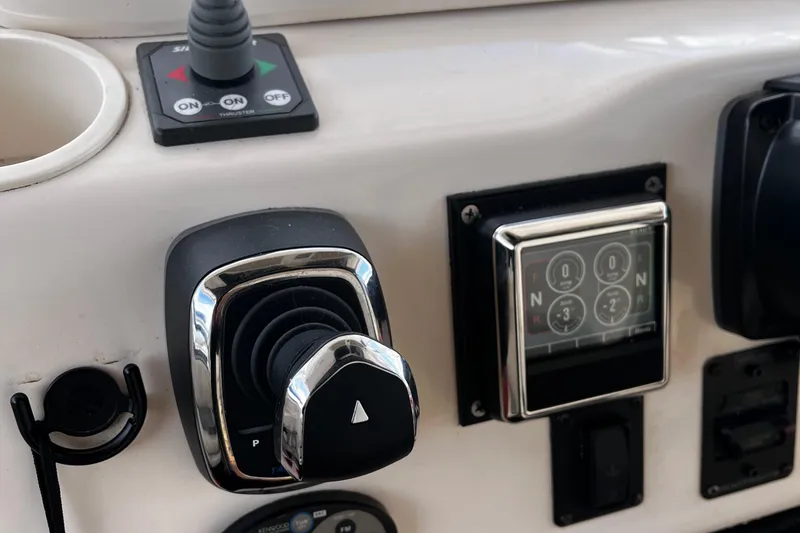 Slide: The Image of Control panel of a 2003 Grady-White 33 Express boat, featuring joystick and switches. - 9