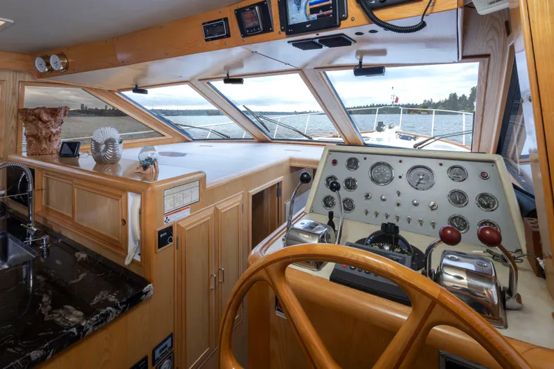 Slide: The Image of 1989 Ocean Alexander 50 Sedan helm with wooden steering wheel and panoramic windows. - 16