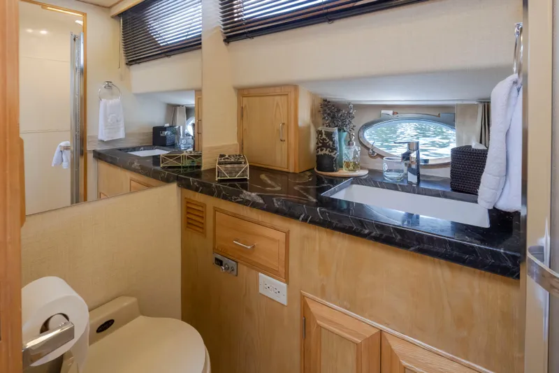Slide: The Image of Luxurious bathroom interior of 1989 Ocean Alexander 50 Sedan yacht with elegant fixtures. - 17