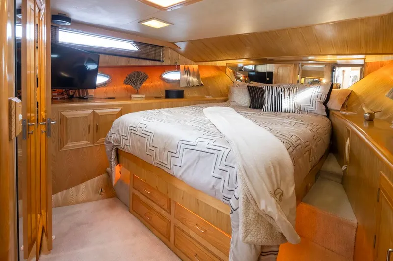 Slide: The Image of Luxurious bedroom interior of 1989 Ocean Alexander 50 Sedan yacht with elegant bedding. - 18