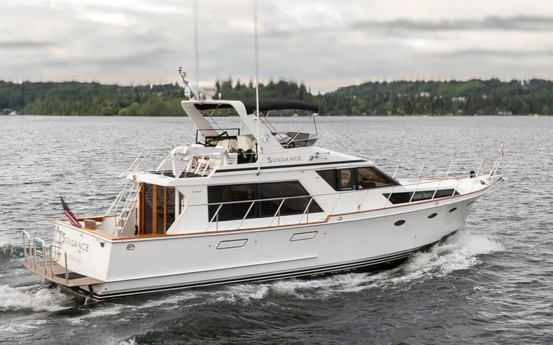 Slide: The Image of 1989 Ocean Alexander 50 Sedan yacht cruising on a calm lake with forested shoreline. - 2