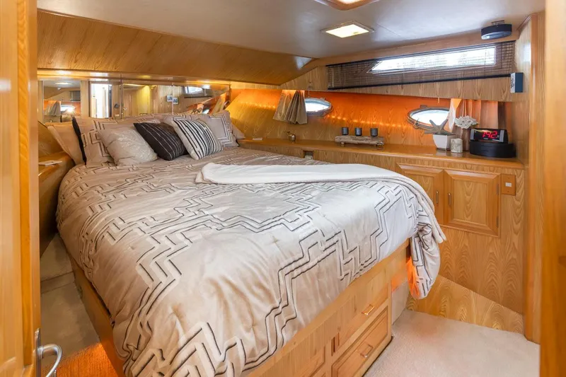 Slide: The Image of Luxurious bedroom interior of 1989 Ocean Alexander 50 Sedan yacht with elegant bedding and wood finishes. - 21