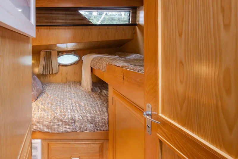 Slide: The Image of Cozy cabin interior of 1989 Ocean Alexander 50 Sedan with wooden finish and bunk beds. - 25