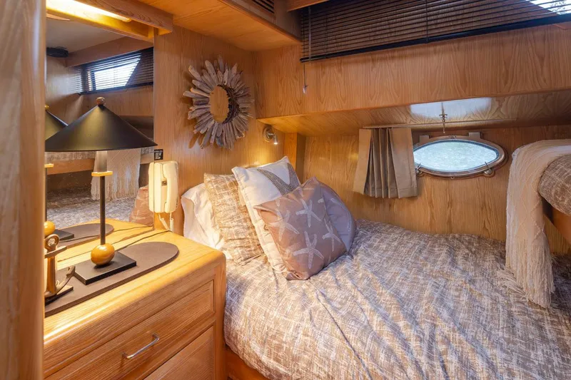 Slide: The Image of Cozy bedroom interior of 1989 Ocean Alexander 50 Sedan yacht with wooden decor and soft lighting. - 26