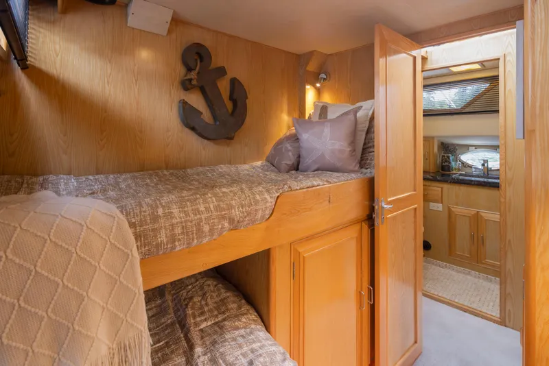 Slide: The Image of Cozy cabin interior of 1989 Ocean Alexander 50 Sedan with wooden bunk beds and nautical decor. - 27