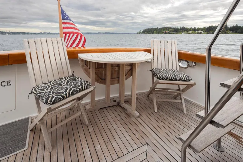 Slide: The Image of 1989 Ocean Alexander 50 Sedan yacht deck with chairs, table, and American flag. - 31