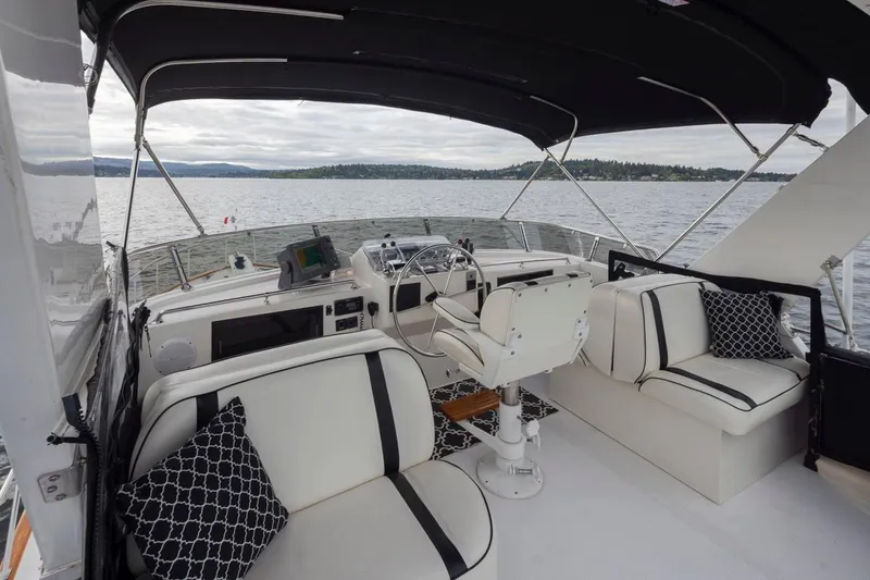 Slide: The Image of 1989 Ocean Alexander 50 Sedan yacht interior with elegant seating and scenic water view. - 32