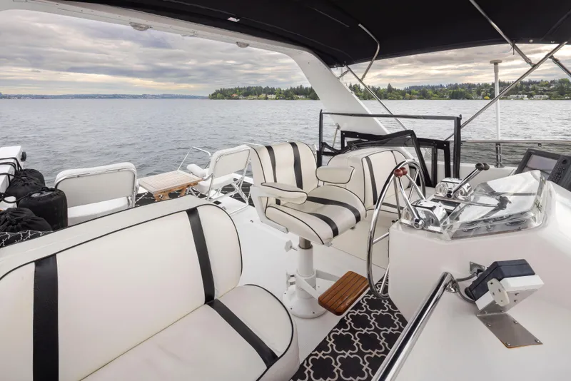 Slide: The Image of 1989 Ocean Alexander 50 Sedan yacht interior with elegant seating and scenic water view. - 34