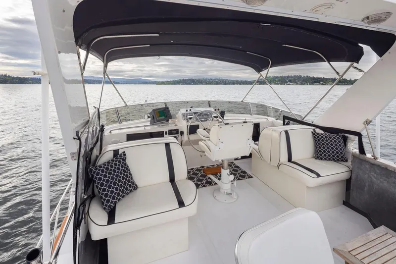 Slide: The Image of 1989 Ocean Alexander 50 Sedan yacht interior with seating, steering, and water view. - 37