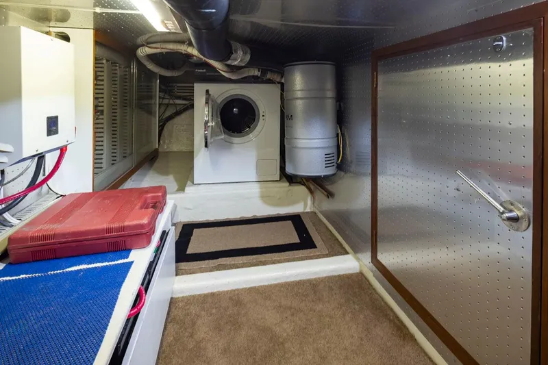 Slide: The Image of Laundry area in 1989 Ocean Alexander 50 Sedan yacht with washer and storage. - 38