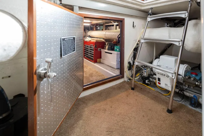 Slide: The Image of Engine room of 1989 Ocean Alexander 50 Sedan with tools and equipment. - 40