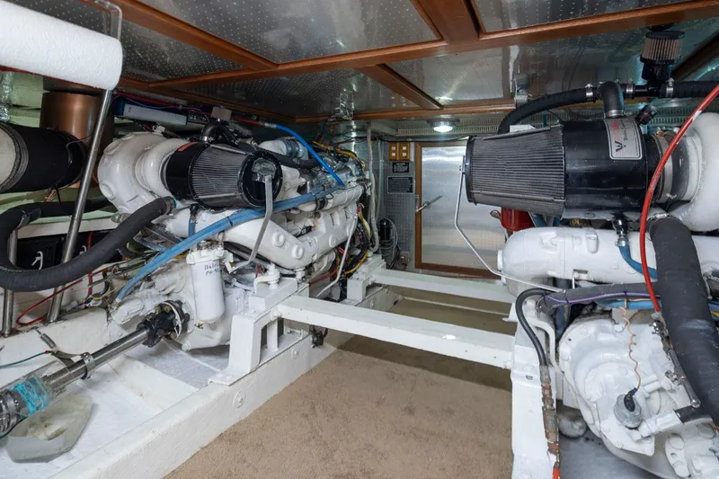 Slide: The Image of Engine room of 1989 Ocean Alexander 50 Sedan with dual engines and mechanical components. - 43