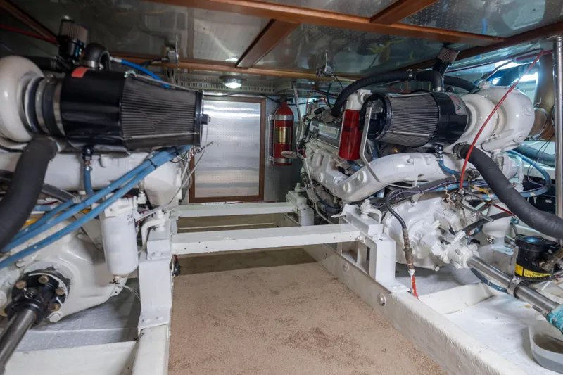 Slide: The Image of Engine room of 1989 Ocean Alexander 50 Sedan with dual engines and fire extinguisher. - 44