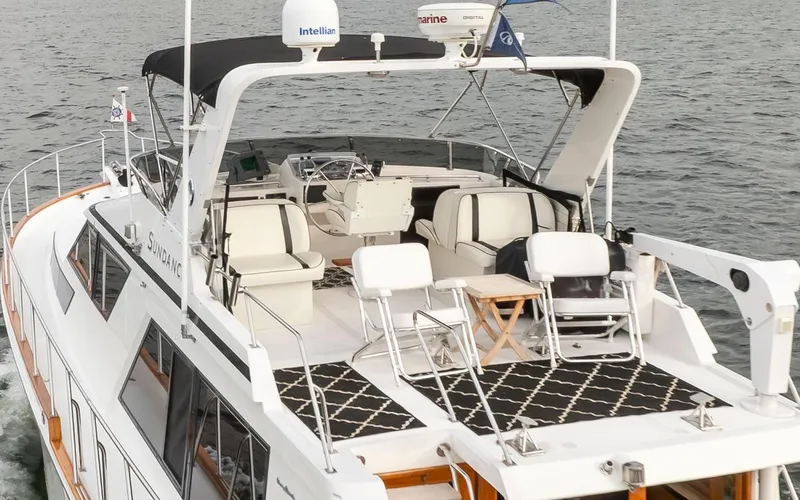 Slide: The Image of 1989 Ocean Alexander 50 Sedan yacht with spacious deck and seating, cruising on water. - 5