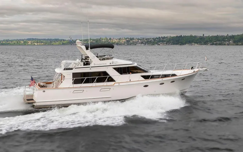 Slide: The Image of 1989 Ocean Alexander 50 Sedan yacht cruising on open water under cloudy skies. - 9