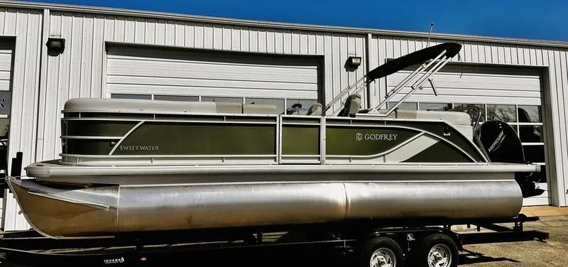 Slide: The Image of 2025 Godfrey Sweetwater 2286 SB pontoon boat with iMPACT Package, parked outside a garage. - 10