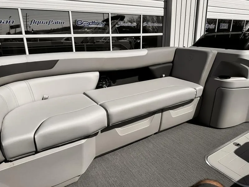 Slide: The Image of 2025 Godfrey SWEETWATER 2286 SB boat interior with gray seating and modern design. - 7