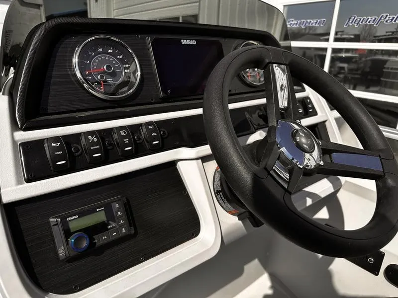 Slide: The Image of 2025 Godfrey Sweetwater 2286 SB boat dashboard with steering wheel and control panel. - 9
