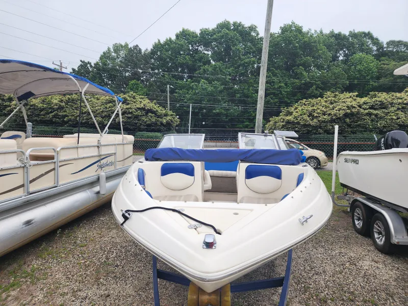 Slide: The Image of 2003 Mariah Bow Rider SX9 boat displayed outdoors, surrounded by other boats. - 1