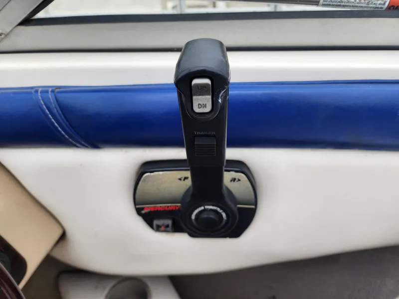 Slide: The Image of Throttle control of 2003 Mariah Bow Rider SX9 boat with blue and white interior. - 12