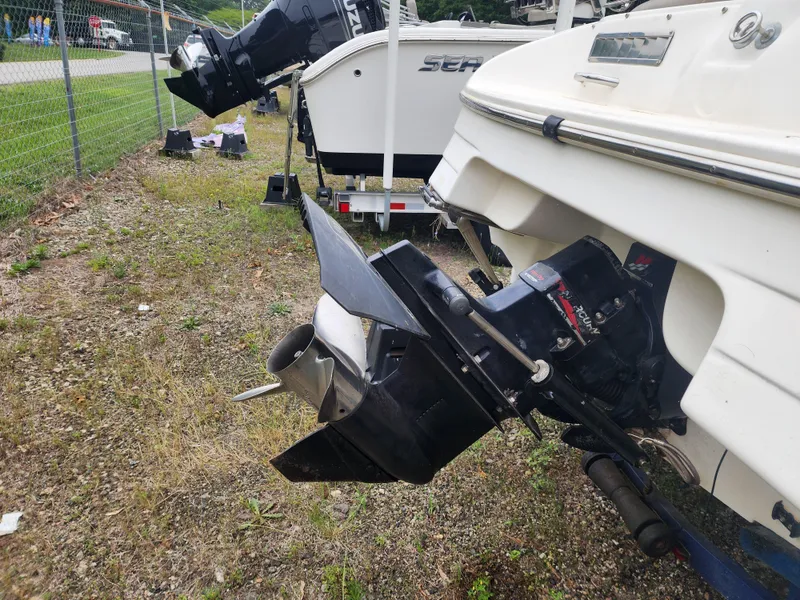 Slide: The Image of 2003 Mariah Bow Rider SX9 boat with outboard motor, parked on grass. - 15