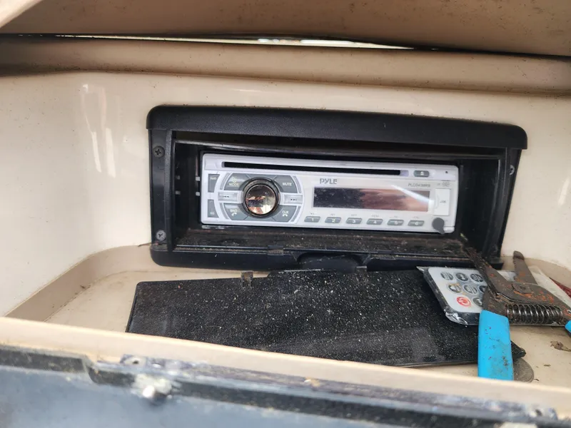 Slide: The Image of 2003 Mariah Bow Rider SX9 stereo system with remote control in dashboard compartment. - 16