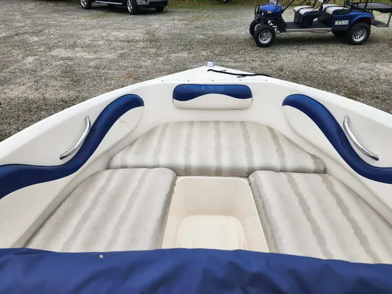 Slide: The Image of 2003 Mariah Bow Rider SX9 boat interior with blue and white seating. - 7