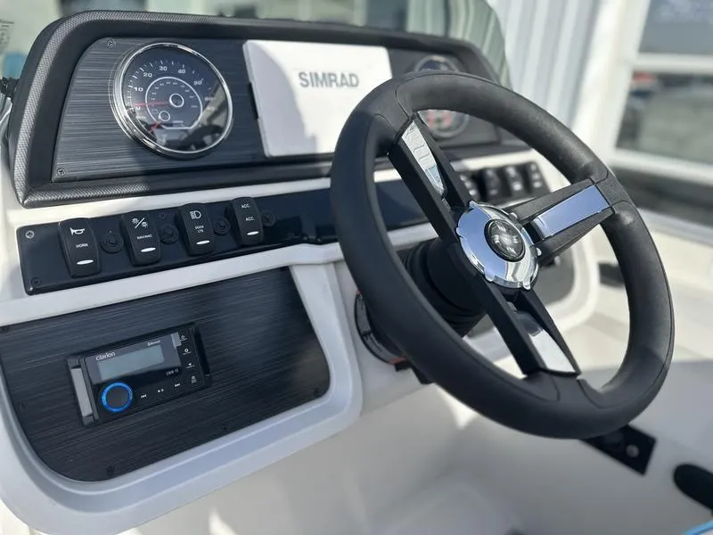 Slide: The Image of Steering console of 2025 Godfrey Sweetwater 2286 SB boat with modern controls and Simrad display. - 11