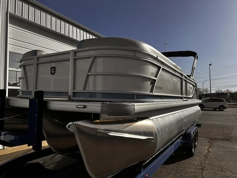 Slide: The Image of 2025 Godfrey Sweetwater 2286 SB pontoon boat on trailer, parked outdoors. - 5